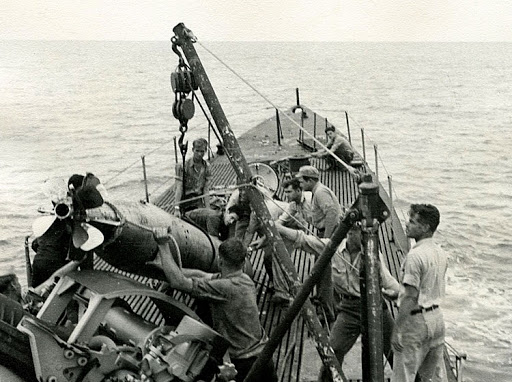 Bob (top left) helping crew of Besugo retrieve Japanese torpedo, circa 1946-'47