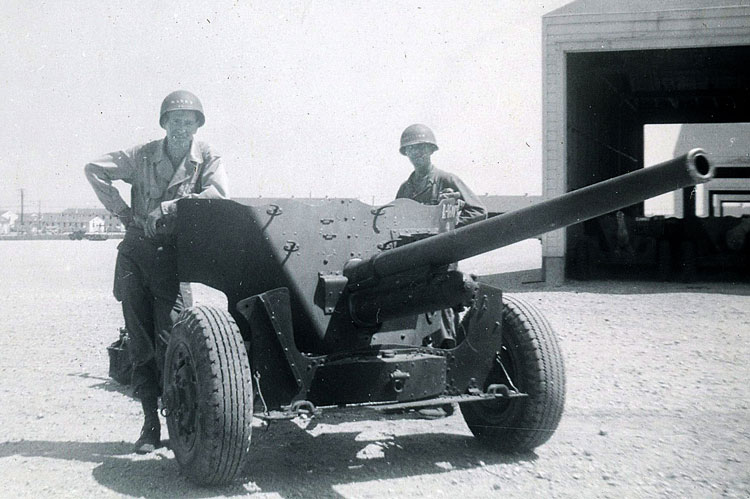 Joe (at right) next to 57mm anti-tank gun